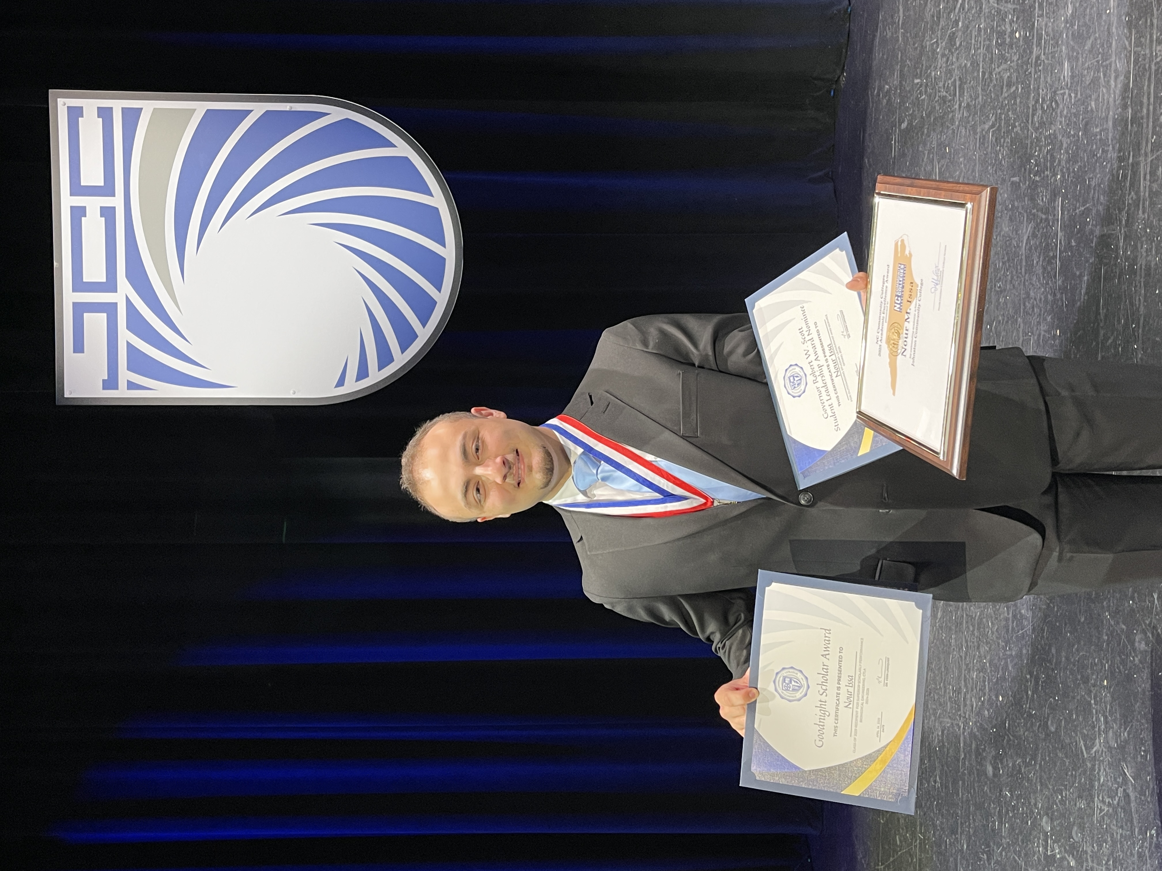 Nour Issa holding awards